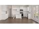 Bright kitchen features white cabinets, stainless appliances, and an island with elegant turned legs at 1139 Blue Juniper Cir, Loganville, GA 30052