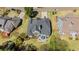 Aerial view displays home with dark roof, manicured lawn, and patio dining set between well-spaced neighboring houses at 135 Ardsley Run, Canton, GA 30115