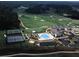 Aerial view of the neighborhood golf course, clubhouse, tennis courts, and swimming pool at 135 Ardsley Run, Canton, GA 30115