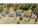 Aerial view displays a suburban neighborhood filled with lush trees and well-maintained homes at 135 Ardsley Run, Canton, GA 30115