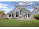 Exterior view of the home featuring a deck, mature landscaping, and ample outdoor space at 135 Ardsley Run, Canton, GA 30115