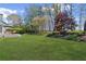 View of a well-maintained backyard with a table set under an umbrella on the patio at 135 Ardsley Run, Canton, GA 30115