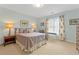Cozy bedroom featuring a large window with patterned curtains and neutral decor at 135 Ardsley Run, Canton, GA 30115