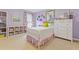Colorful bedroom with a bookshelf filled with books and decorative pieces at 135 Ardsley Run, Canton, GA 30115