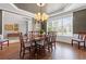 Elegant dining room with a chandelier, hardwood floors, and large windows at 135 Ardsley Run, Canton, GA 30115