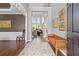 Bright foyer featuring hardwood floors, bench, and elegant decor at 135 Ardsley Run, Canton, GA 30115