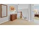 Second floor landing with decorative furnishings and an open door to a bedroom at 135 Ardsley Run, Canton, GA 30115