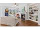 Comfortable living room with fireplace, built-in shelving, hardwood floors and view to backyard at 135 Ardsley Run, Canton, GA 30115