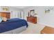 Comfortable main bedroom features a bed, dressers, and view into main bathroom at 135 Ardsley Run, Canton, GA 30115