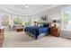 Spacious main bedroom featuring sitting area, ceiling fan and natural light from bay windows at 135 Ardsley Run, Canton, GA 30115