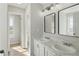 A modern bathroom with a double sink vanity, framed mirrors, and view into other rooms at 176 Villa Rosa Rd, Temple, GA 30179