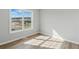 Bright bedroom with wood-look flooring, neutral walls, and a large window at 176 Villa Rosa Rd, Temple, GA 30179