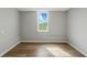 The bedroom has wood-look flooring, a window, and neutral walls at 176 Villa Rosa Rd, Temple, GA 30179