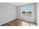 Bedroom with large window, wood-look flooring, and gray walls at 176 Villa Rosa Rd, Temple, GA 30179