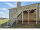 Back exterior of house featuring deck with stairs on a lush green lawn at 176 Villa Rosa Rd, Temple, GA 30179