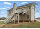 A rear house view with a deck and stairs that lead to a grassy backyard at 176 Villa Rosa Rd, Temple, GA 30179