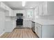 Modern kitchen features white cabinets, stainless steel appliances, and a corner sink at 176 Villa Rosa Rd, Temple, GA 30179
