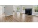 Spacious living room featuring wood-look floors, a fireplace, and sliding glass doors to a deck at 176 Villa Rosa Rd, Temple, GA 30179