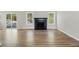 Open-concept living room with wood-look floors, a fireplace, and sliding glass doors to a deck at 176 Villa Rosa Rd, Temple, GA 30179