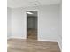 Bright living room with light wood floors, neutral walls, and doorway to another room at 176 Villa Rosa Rd, Temple, GA 30179