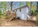 Backyard view featuring a wooden deck, white brick and mature trees at 2168 Doris Dr, Decatur, GA 30034