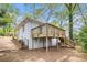 Exterior view of house featuring a wooden deck and landscaped backyard at 2168 Doris Dr, Decatur, GA 30034
