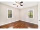 Cozy bedroom with hardwood floors, a ceiling fan, and two windows at 2168 Doris Dr, Decatur, GA 30034