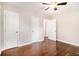 Bedroom with ceiling fan, hardwood floors, and three closets/doorways at 2168 Doris Dr, Decatur, GA 30034