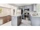 Modern kitchen with stainless steel appliances, gray cabinetry, and a kitchen island at 2168 Doris Dr, Decatur, GA 30034
