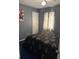 A cozy bedroom featuring dark bedding, a ceiling fan, and plush blue carpet at 3833 Brookstone Way, Ellenwood, GA 30294