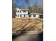 Charming two-story home featuring a well-maintained lawn and complemented by mature trees at 3833 Brookstone Way, Ellenwood, GA 30294