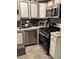 Kitchen featuring stainless steel appliances, tiled floors, and ample cabinet space at 3833 Brookstone Way, Ellenwood, GA 30294