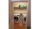 A laundry room featuring a washer, dryer, and storage shelves for supplies at 3833 Brookstone Way, Ellenwood, GA 30294