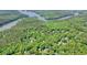 Lush forest with homes nestled in the trees with water in the distance at 1514 Maplewood Ct, Woodstock, GA 30189