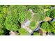 Aerial view of home surrounded by mature trees and lush landscaping at 1514 Maplewood Ct, Woodstock, GA 30189