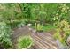 Wooden back deck with potted plants, overlooking a lush wooded area at 1514 Maplewood Ct, Woodstock, GA 30189