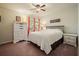 Bright bedroom featuring white dresser, hardwood floors, colorful wall art and curtains, creating a cheerful ambiance at 1514 Maplewood Ct, Woodstock, GA 30189