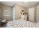 Comfortable bedroom features neutral walls and trim, carpeted floors, chair, and a ladder leaning on a dresser at 1514 Maplewood Ct, Woodstock, GA 30189