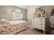 Cozy bedroom with bright floral bedding, natural light, and vintage dresser, creating a comfortable, inviting space at 1514 Maplewood Ct, Woodstock, GA 30189