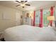 Bright bedroom featuring white dresser, hardwood floors, colorful curtains and lamps, creating a cheerful ambiance at 1514 Maplewood Ct, Woodstock, GA 30189