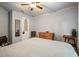 Bedroom with a neutral palette, ceiling fan, and hardwood furniture, offers a tranquil and inviting retreat at 1514 Maplewood Ct, Woodstock, GA 30189