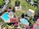 Aerial view showcasing tennis courts, basketball court and a swimming pool within a wooded community setting at 1514 Maplewood Ct, Woodstock, GA 30189
