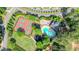 Aerial view featuring tennis courts, swimming pool and playground for the community with mature landscaping at 1514 Maplewood Ct, Woodstock, GA 30189