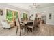 Spacious dining room with wood floors, large windows, and ample seating for Gathering and friends at 1514 Maplewood Ct, Woodstock, GA 30189
