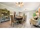 Bright dining space boasts hardwood floors, a large table with seating for eight and abundant natural light at 1514 Maplewood Ct, Woodstock, GA 30189