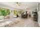 Open dining room features wood floors, ceiling fans, and plenty of natural light from multiple windows at 1514 Maplewood Ct, Woodstock, GA 30189