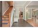 Inviting foyer with hardwood floors, staircase, and views into the living spaces at 1514 Maplewood Ct, Woodstock, GA 30189