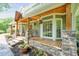 Inviting front porch with stone pillars, hanging plants, and a warm, welcoming atmosphere at 1514 Maplewood Ct, Woodstock, GA 30189