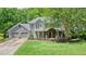 Charming two-story home with a manicured lawn, a welcoming porch, and an attached two-car garage at 1514 Maplewood Ct, Woodstock, GA 30189