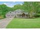 Beautiful two-story home boasts a lush green lawn, a welcoming porch, and a convenient two-car garage at 1514 Maplewood Ct, Woodstock, GA 30189